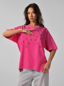 Macro detail of hot-fix rhinestones and letter H pattern on magenta cotton t-shirt