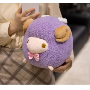 Close-up of cute purple plush sheep toy with golden embroidered eyes and pink bow