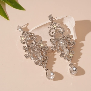 Elegant sparkling silver tassel earrings with teardrop crystals and ornate rhinestone floral patterns