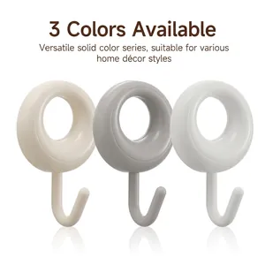Three-piece wall mounted adhesive hooks in beige, grey and white for home organization