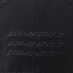 Classic black cotton baseball cap featuring 3D letter embroidery in a minimalist style