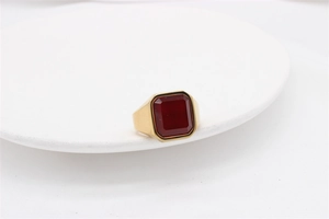 Detailed view of square-cut red ruby set in gold-plated stainless steel wide ring