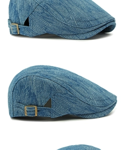 Detail of dark blue denim beret showing bronze adjustable buckle and textile texture