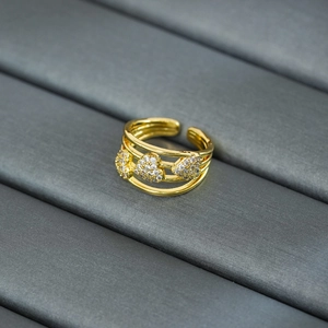 Detail view of gold-plated triple heart ring with zircon stones and adjustable band
