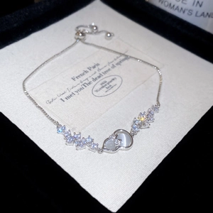 Macro view of adjustable floral bracelet featuring zircons and opal stone interlocking detail