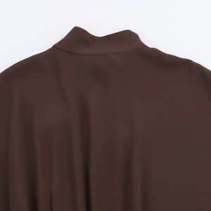 Close-up of the stitching on a dark brown long dress collar with a silky finish