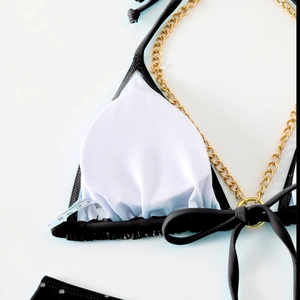Detail of bikini top showing gold chain strap and breathable white mesh lining