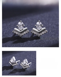 Macro view of marquise-cut zircon stud earrings with V-shaped diamond accents
