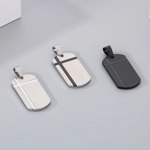 Detailed view of stainless steel cross pendants in silver, gunmetal, and matte black finishes