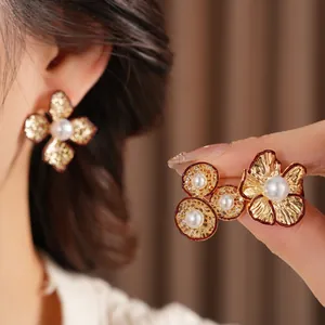Elegant gold flower pearl earrings set featuring brushed metal texture and vintage design