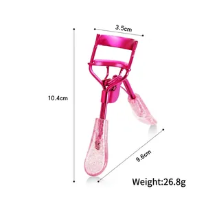 Pink metal eyelash curler with glitter handle showing size dimensions 10.4cm x 3.5cm