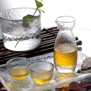 Close-up of textured hammer pattern glass wine set with decanter and tray in light setup