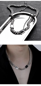 Detail of silver Cuban chain with square zircon and black enamel pendants for men