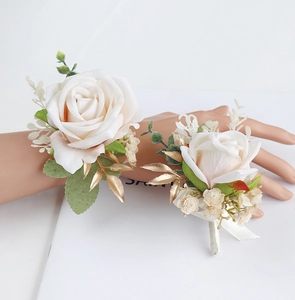 Close-up of elegant silk rose wrist corsage and boutonniere for wedding guests