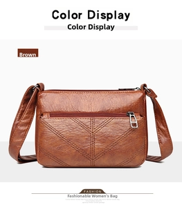 Detailed view of brown leather bag featuring lychee texture and dual zipper compartments