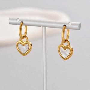 Close-up of 18K gold-plated heart earrings with white shell inlay and ribbed edges
