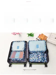 Polka dot travel packing cubes set in navy blue with mesh panels and zipper closures
