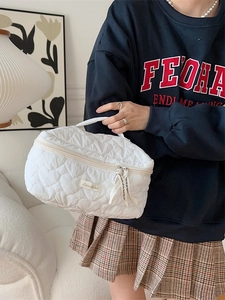 Quilted heart pattern makeup bag in white with sturdy handle and dual zippers