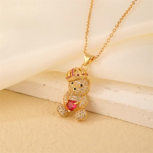 Macro detail of gold bear pendant with micro-pave zircons on a white stone base