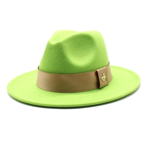 Detail of lime green fedora with light brown band and gold bee metal ornament