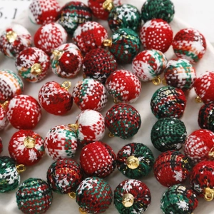 Close-up of Christmas plaid cloth ball pendants with gold loops for DIY jewelry making