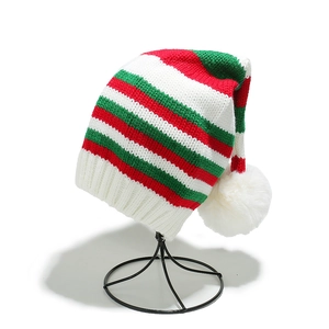 Festive red, green and white striped knit Christmas hat with soft white pompom topper