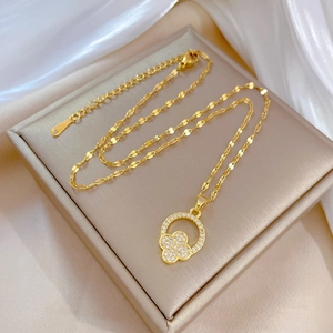 Elegant gold titanium steel necklace featuring a sparkling clover pendant in a diamond ring
