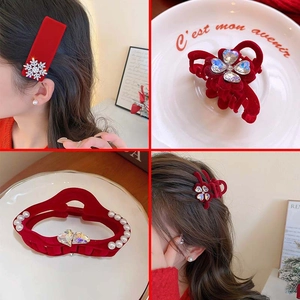 Detailed view of red velvet hair claws with luxury rhinestone snowflakes and pearls