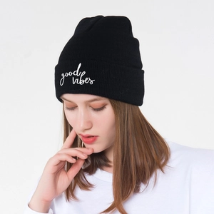 Detailed view of Good Vibes embroidery on a black ribbed knit beanie for autumn and winter