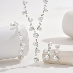 Elegant silver necklace bracelet earring set with white pearls and sparkling rhinestones