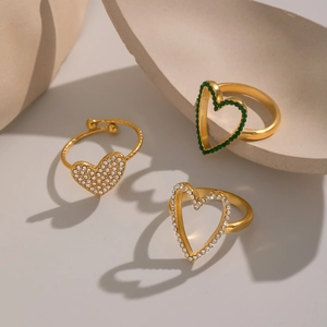 Minimalist gold heart-shaped open rings with white and green zircon stones on base