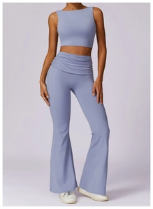 Detail of high waisted flare yoga pants with pleated fold-over waistband in soft lilac