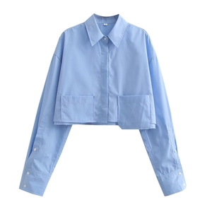 Detailed flat lay of a blue cropped long sleeve shirt with large pockets and collar