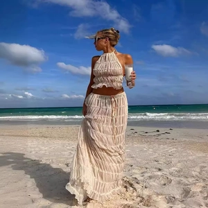 Detail of apricot halter crop top and tiered maxi skirt set for summer beach vacations