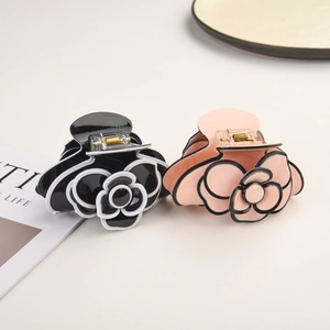 Elegant camellia flower hair claws in black and pink for French style updos