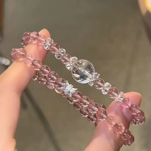 Detail of pink strawberry quartz bracelet with silver bow and clear crystal beads