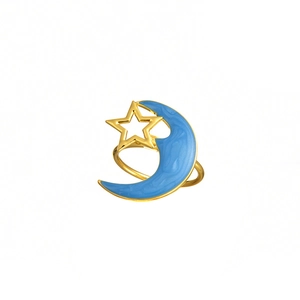 Detail of golden moon and star napkin ring featuring blue enamel finish on white background