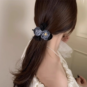 Lace and dark blue rose floral hair claw clip shown on model for elegant styling