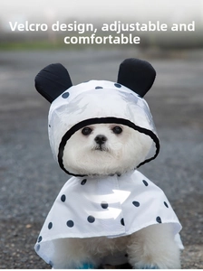 Detail view of dog raincoat featuring a transparent brim and adjustable velcro closure