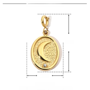 Macro view of gold moon pendant with dimensions 24mm by 12mm on white background