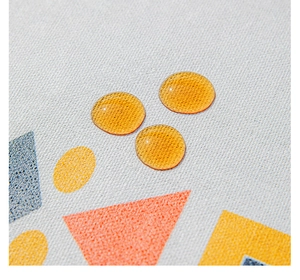 Macro detail showing water-resistant droplets on bohemian geometric linen tablecloth