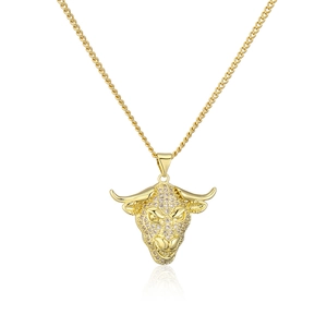 Close-up of 18K gold plated bull head pendant with shimmering cubic zirconia stones