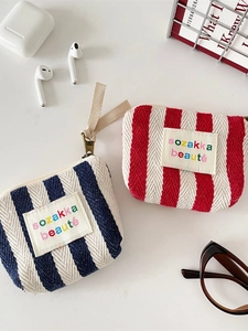 Vertical striped cosmetic bags in navy blue and red with embroidered logo and zipper