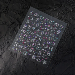 Macro detail of 3D gemstone nail art stickers with silver lines and colored rhinestones