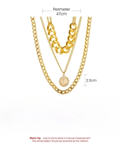 Macro detail of multilayered gold necklace showing coin pendant dimensions and weight