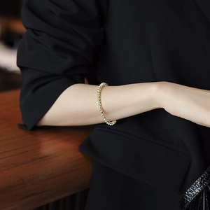 Elegant gold beaded bracelet minimalist geometric metal cuff on female model wrist
