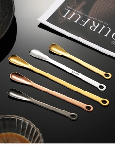 Detailed view of five colorful SUS 304 stainless steel coffee spoons on black mirror surface