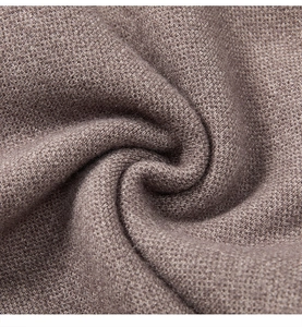 Macro detail of high-quality brown knitted fabric showing texture and soft material layers