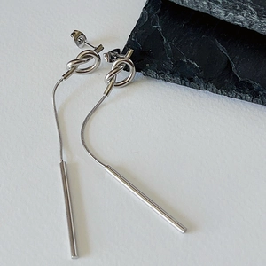 Polished silver knot earrings with long snake chains and solid cylinder pendants