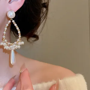 Elegant French vintage drop pearl tassel earrings featuring waterdrop shape on model